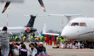 Climate activists swarm private jets at Amsterdam airport to protest pollution
